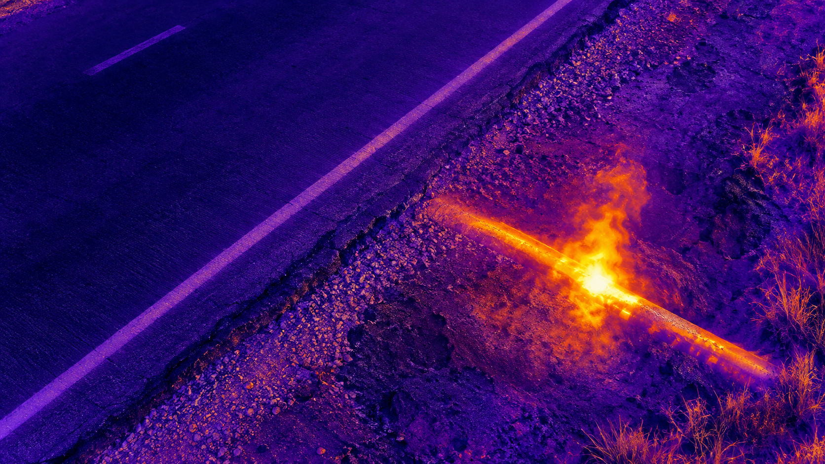 Thermal aerial image of an underground utility line beside a roadway
